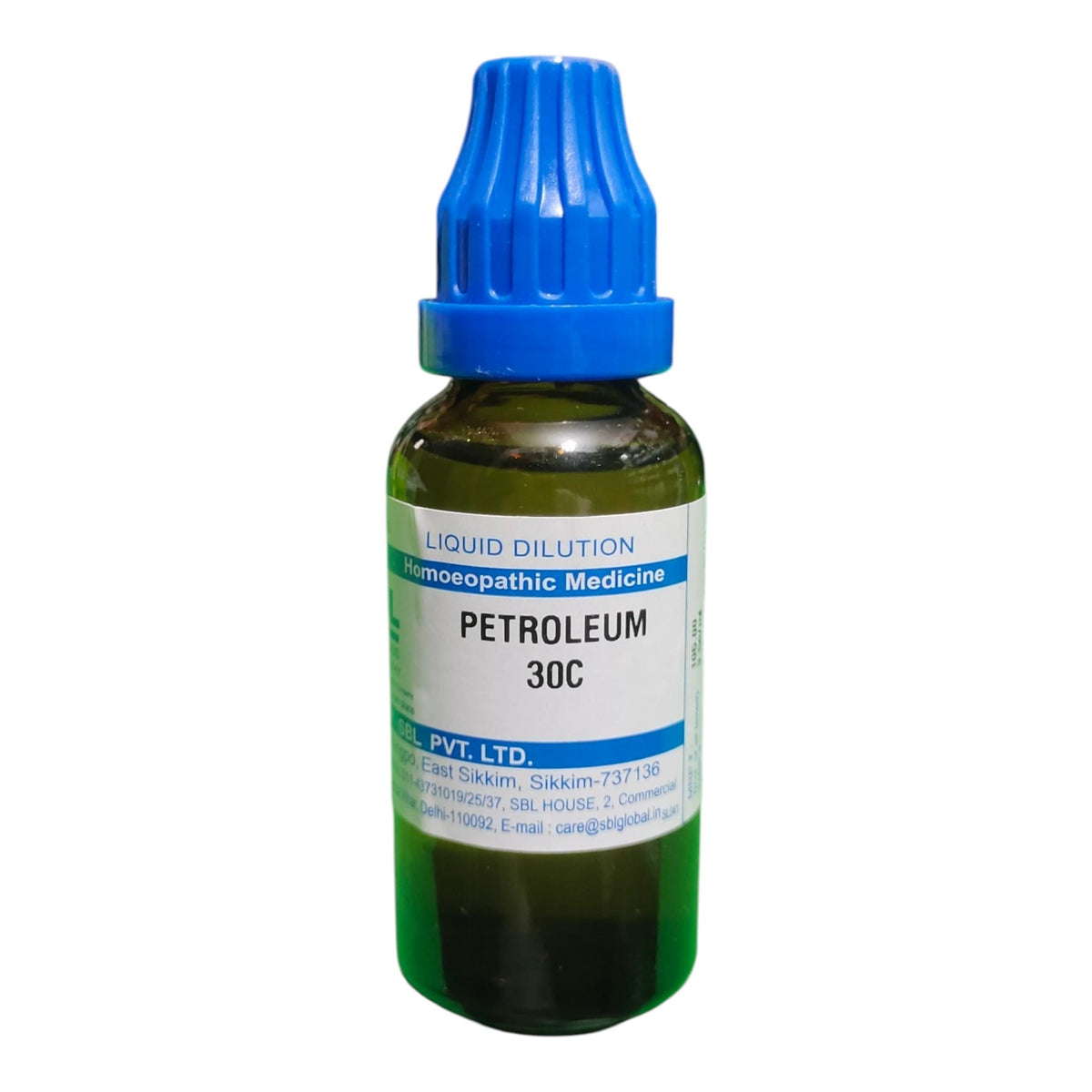 A small amber glass dropper bottle of homeopathic medicine labeled 'PETROLEUM 30C' with a blue cap, on a plain white background.