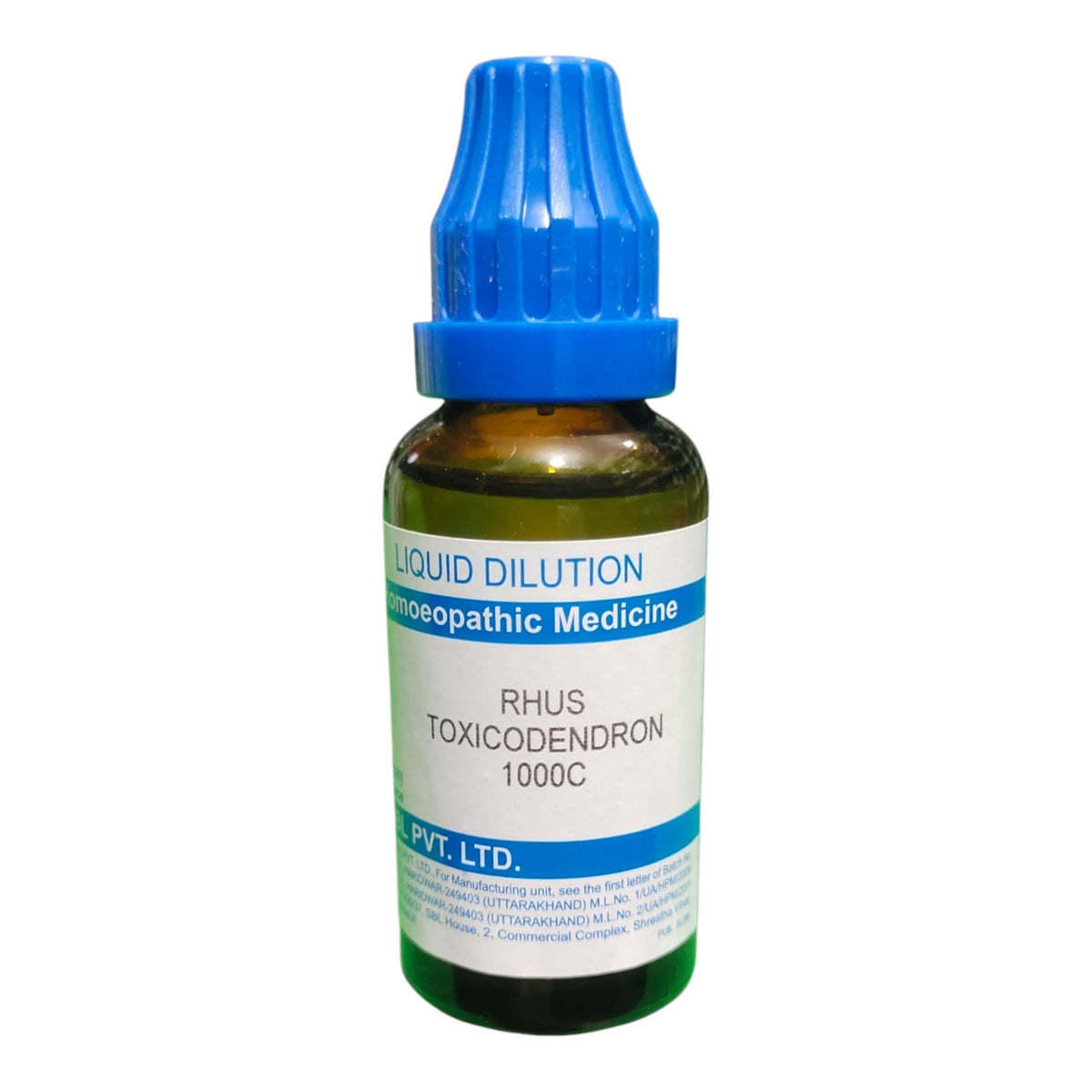 A small amber glass dropper bottle of Rhus Toxicodendron 1000C liquid dilution homeopathic medicine, featuring a blue ribbed cap and a white label with blue text.