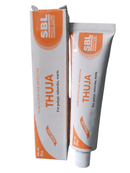 Packaging of Thuja ointment for skin growths, displaying the product tube and box with branding and product information.
