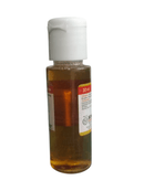Small bottle with a white cap and brown liquid on a white background