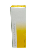 Box of homeopathic medicine with yellow and white design on a white background