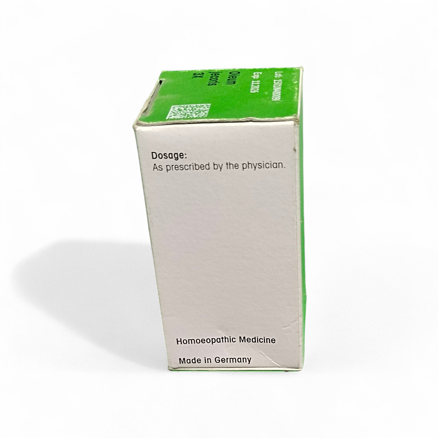 Box of homeopathic medicine with green and white design on a white background