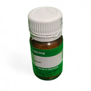 Small brown bottle with a green label and white cap on a white background