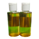 Two bottles with white caps containing a yellowish liquid on a white background