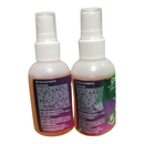 Two spray bottles with purple labels on a white background