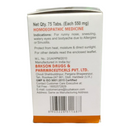 Back view of a homeopathic medicine packaging with text and contact information.