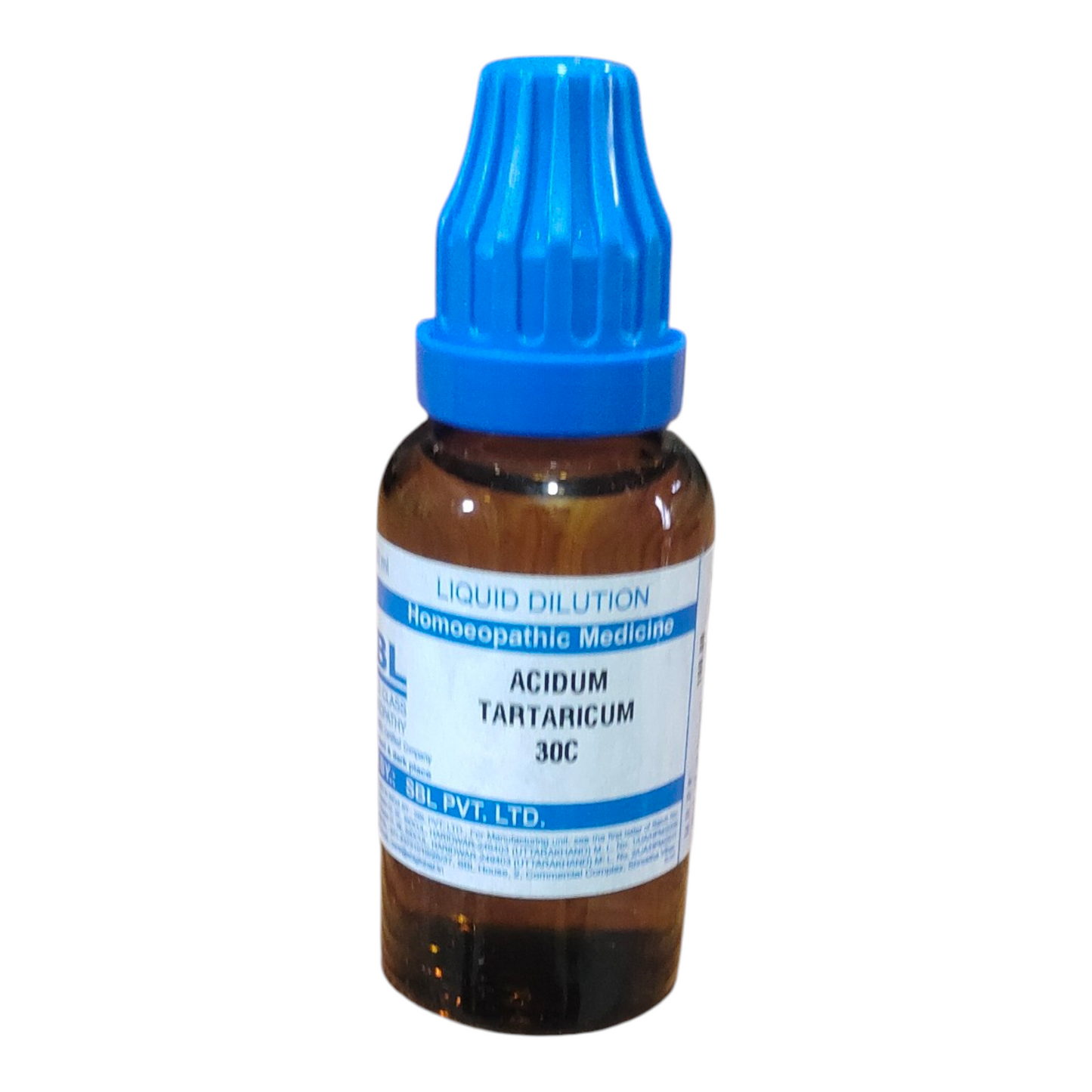Homeopathic medicine bottle with blue cap on a white background