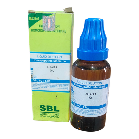 Homoeopathic medicine bottle with blue cap and label next to its packaging on a white background