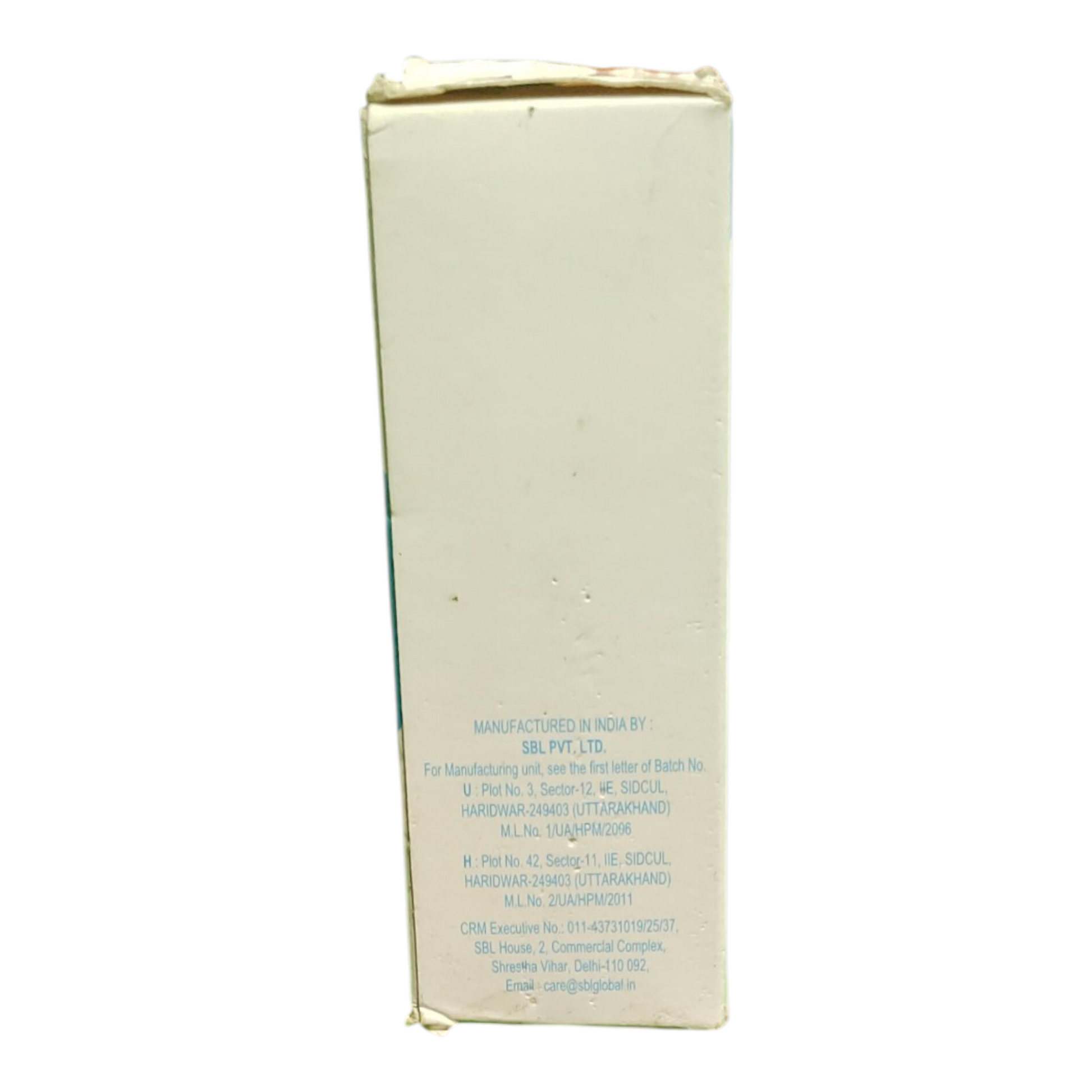 Back view of a white rectangular box with text on a white background