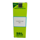Green box of SBL Causticum 30C homoeopathic medicine on a white background