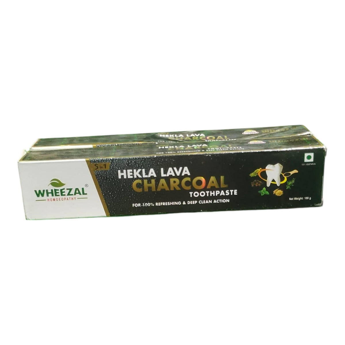 A pack of Wheezal Hekla Lava Charcoal Toothpaste, showing the retail box with a black and white design and gold lettering.