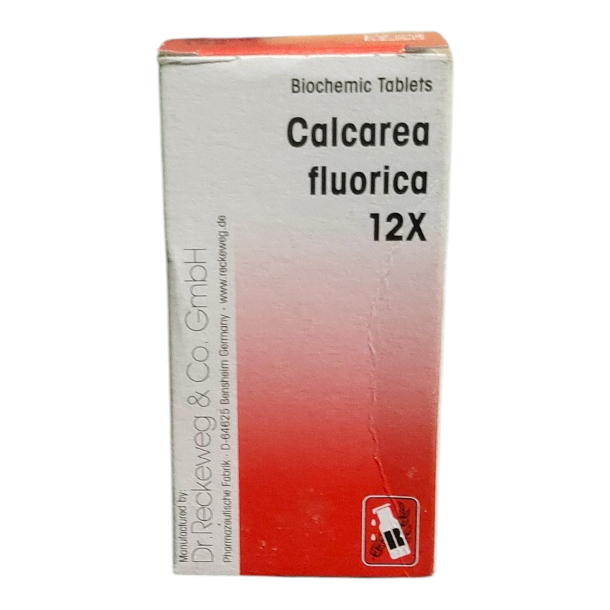 A white and red box of Biochemic Tablets, Calcarea Fluorica 12X, manufactured by Dr. Reckeweg & Co.