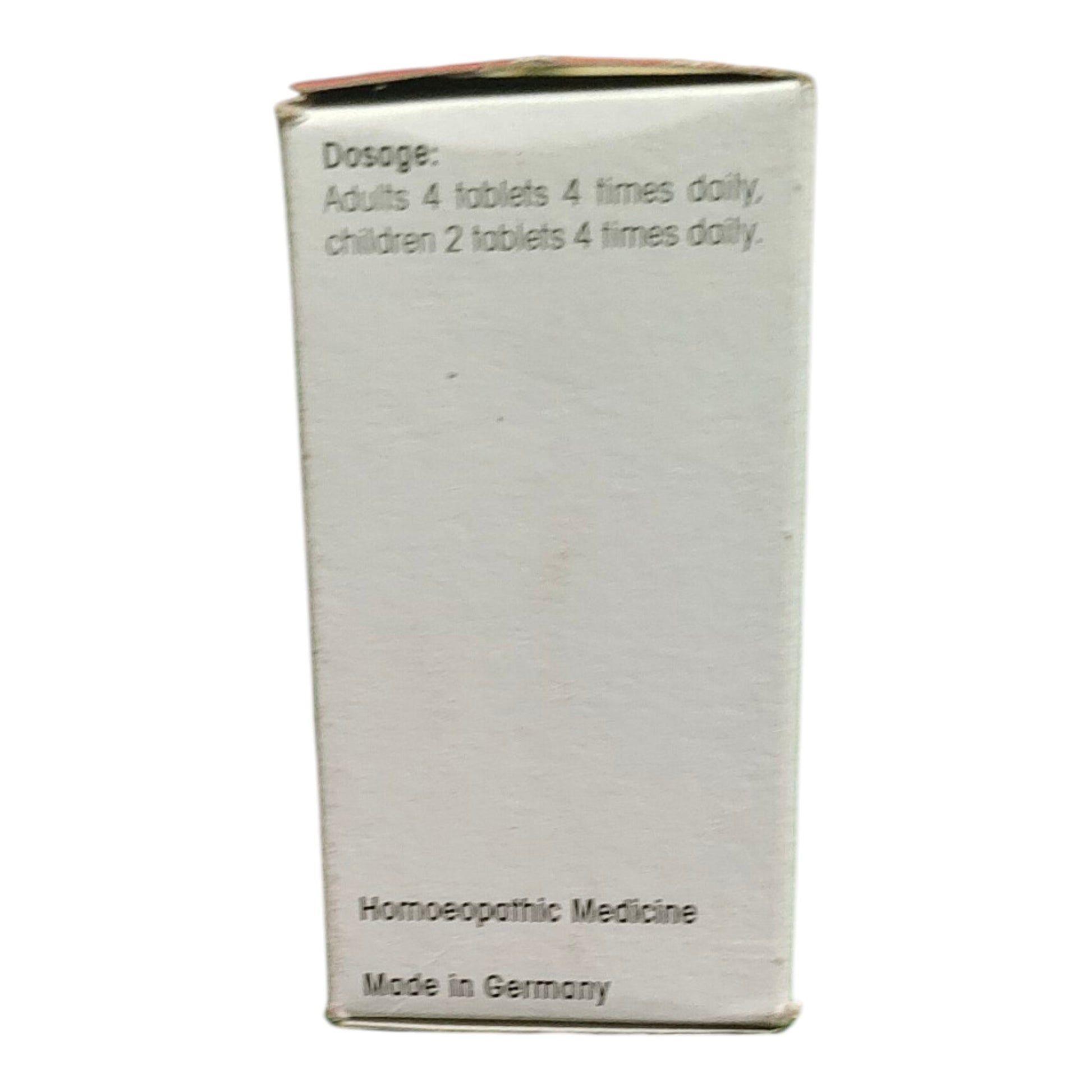 A white cardboard box for homeopathic medicine, showing the dosage instructions and 'Made in Germany' text on a plain white background.