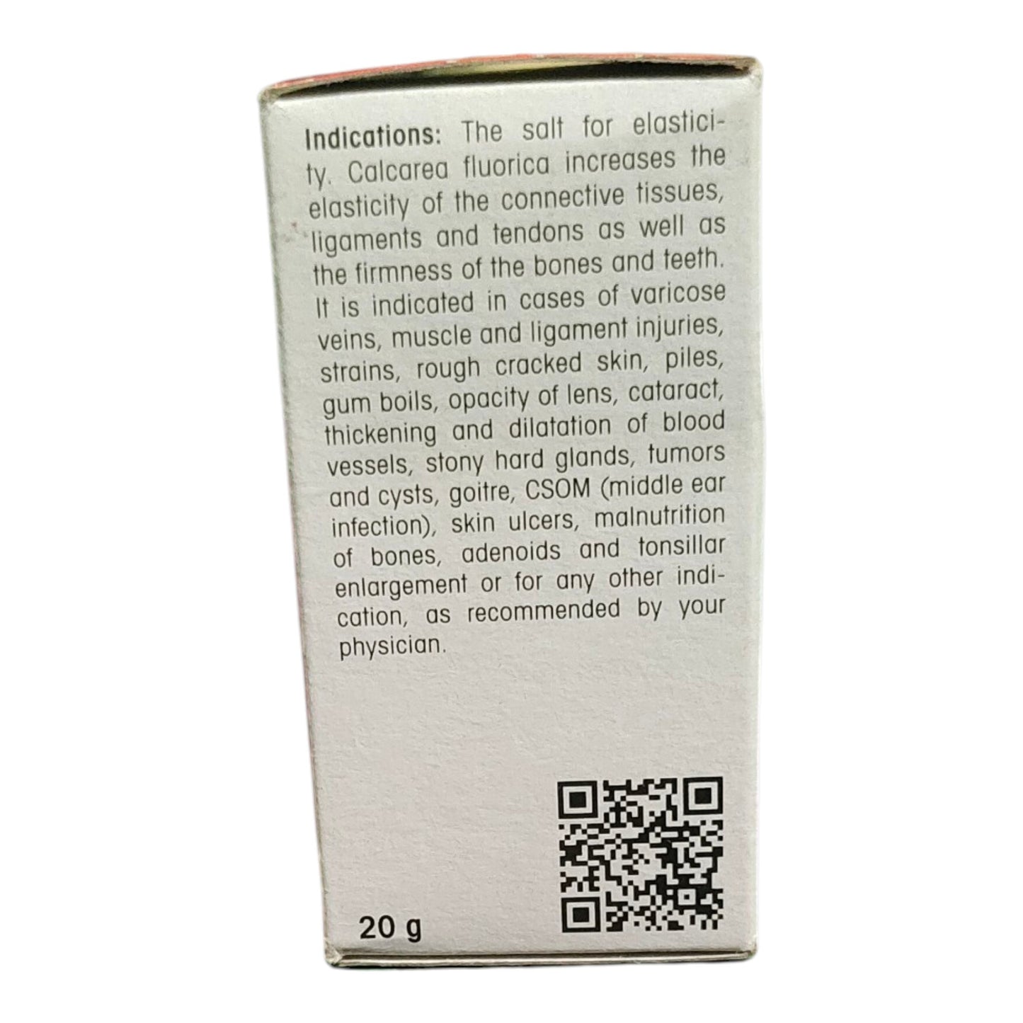 The back of a white cardboard box for Calcarea Fluorica salt, showing product indications in black text, a QR code, and '20 g' at the bottom, photographed against a white background.