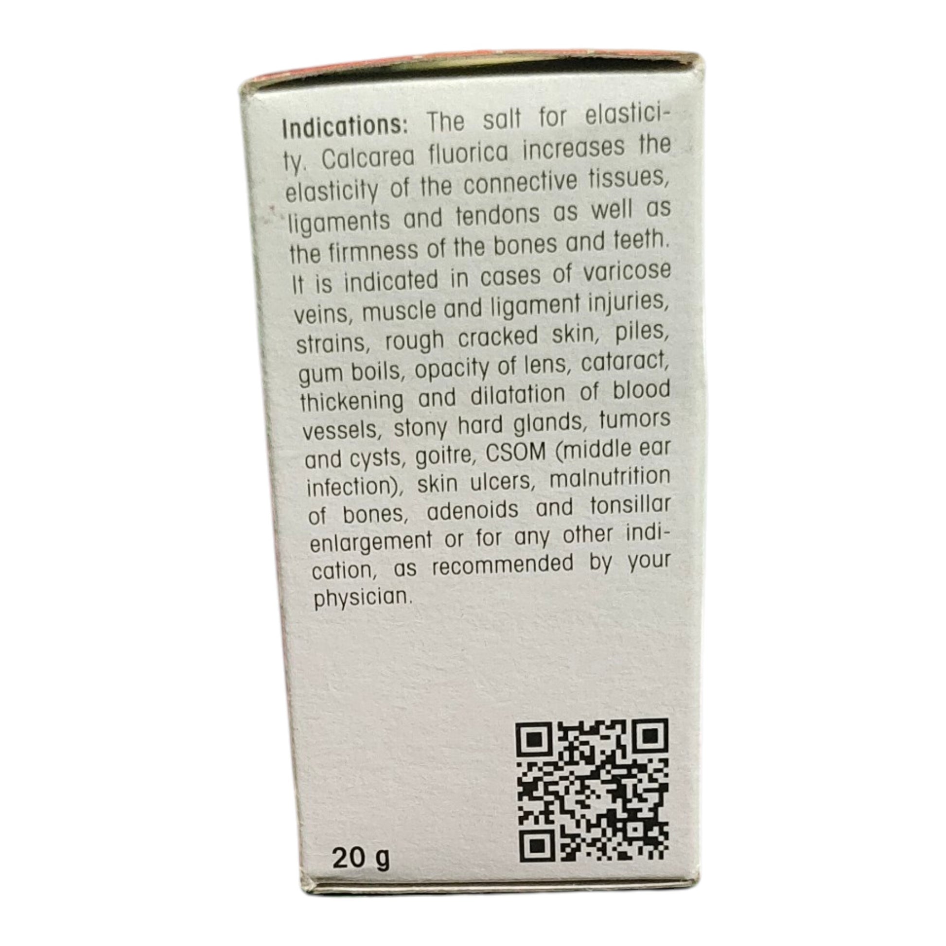 The back of a white cardboard box for Calcarea Fluorica salt, showing product indications in black text, a QR code, and '20 g' at the bottom, photographed against a white background.
