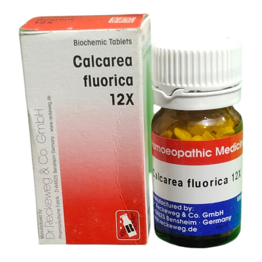 A bottle of Dr. Reckeweg & Co. GmbH Calcarea Fluorica 12X homeopathic tablets next to its white and red packaging box.