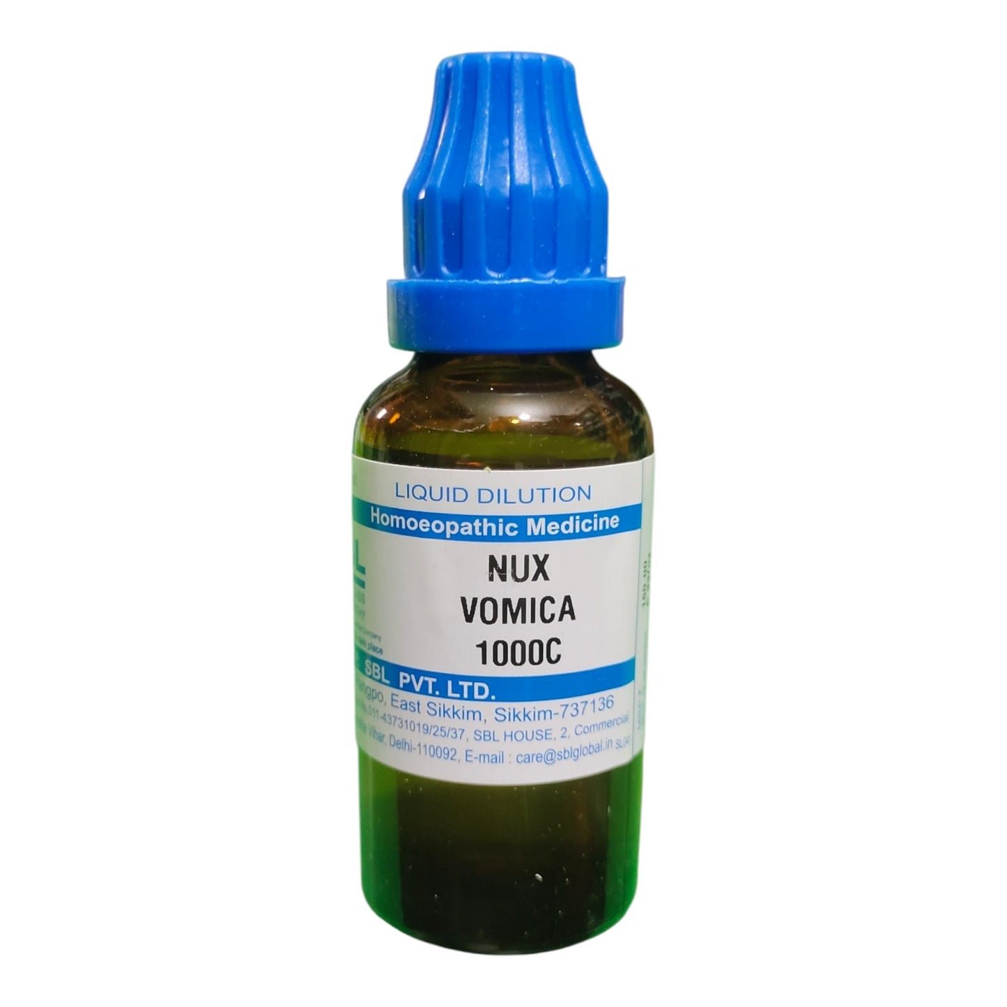 A small amber glass dropper bottle of Nux Vomica 1000C liquid dilution homeopathic medicine with a blue cap and white label, on a white background.