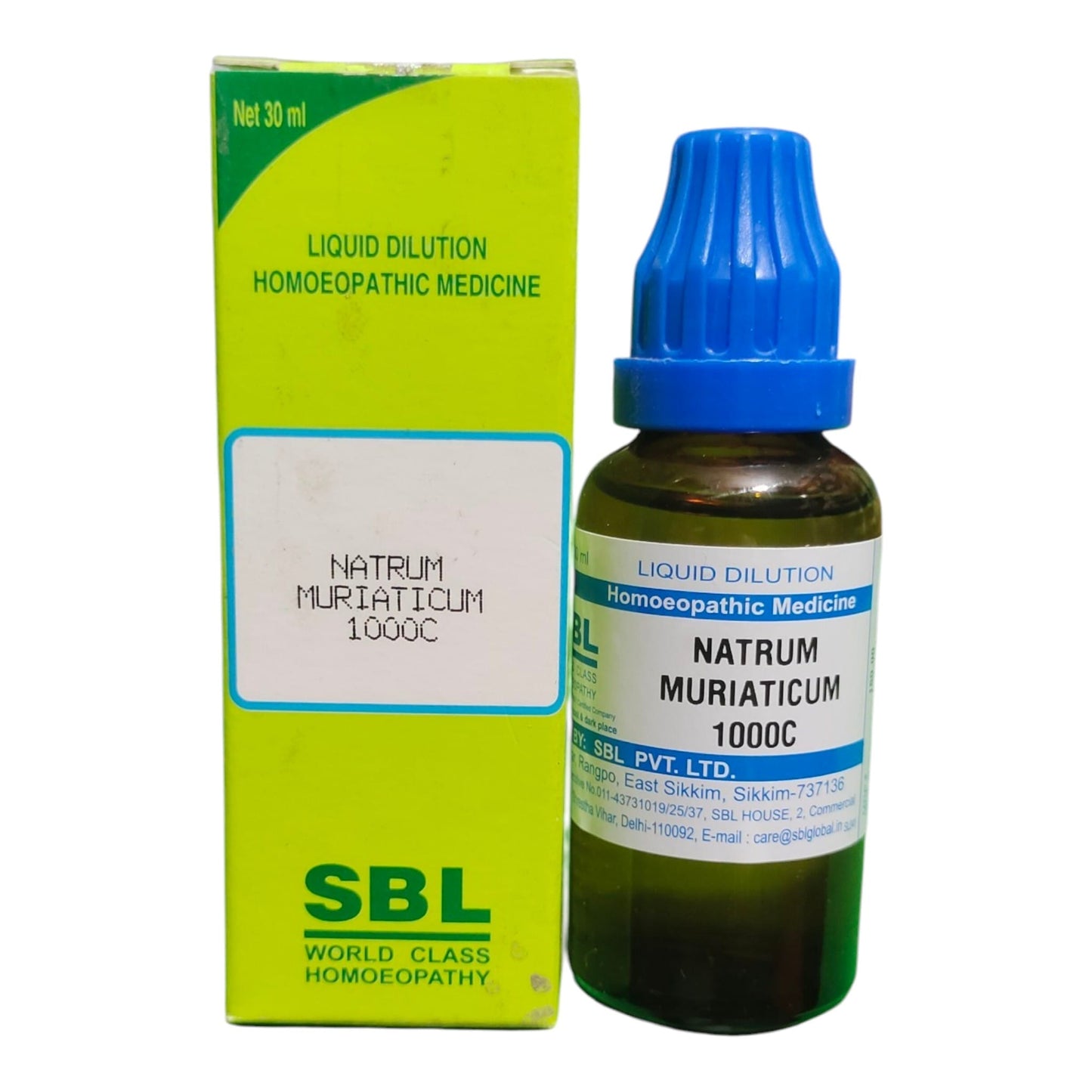 A bottle of SBL World Class Homoeopathy Liquid Dilution Natrum Muriaticum 1000C next to its lime green and white cardboard packaging box, on a plain white background.