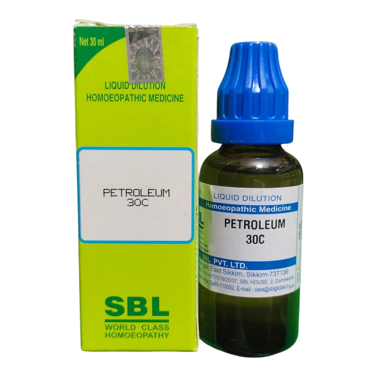 A bottle of Petroleum 30C homeopathic medicine next to its lime green and white packaging box, featuring a blue dropper cap and SBL branding.