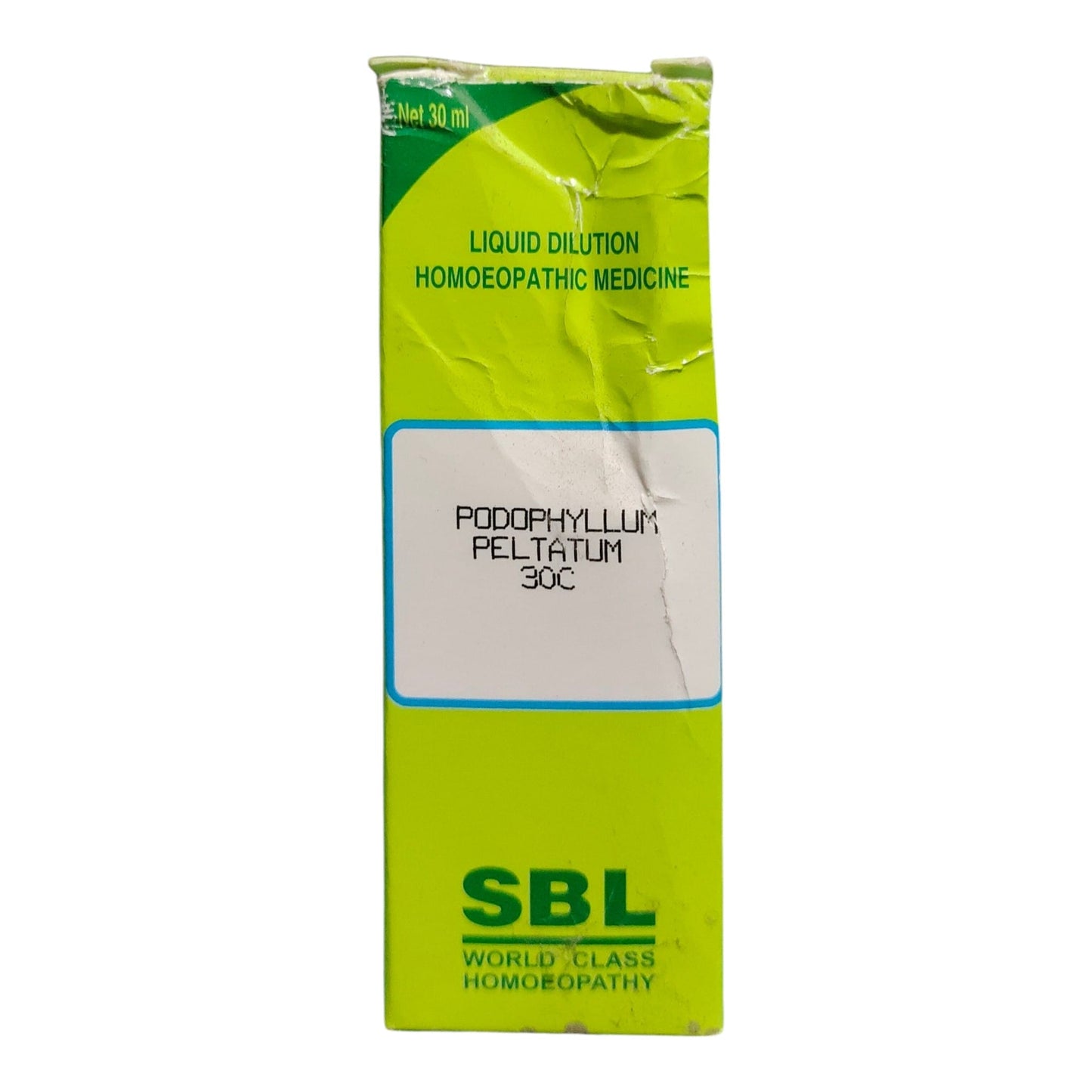 A crumpled lime-green cardboard box of SBL Poddophyllum Feltatum 30c liquid dilution homeopathic medicine, shown against a plain white background.