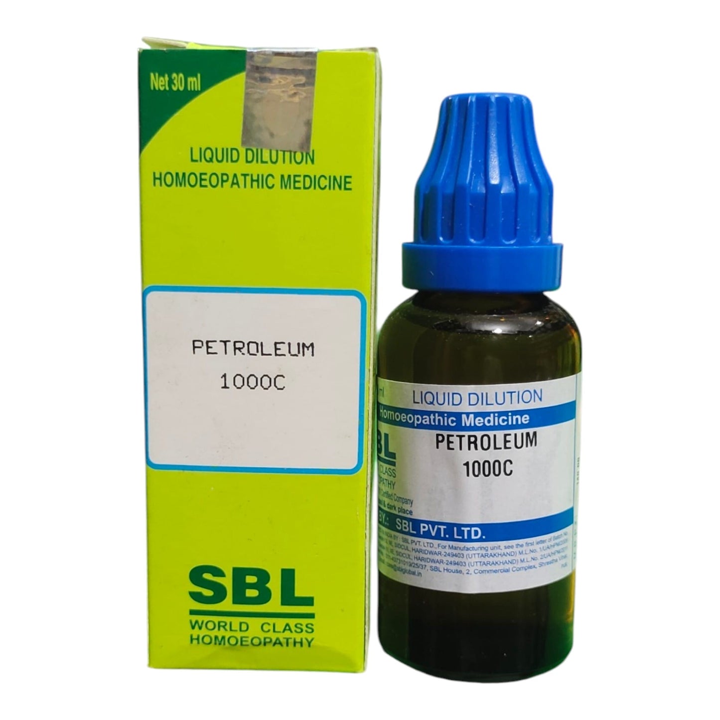 A bottle of SBL Petroleum 1000C liquid dilution homeopathic medicine next to its lime green and white packaging box, on a plain white background.