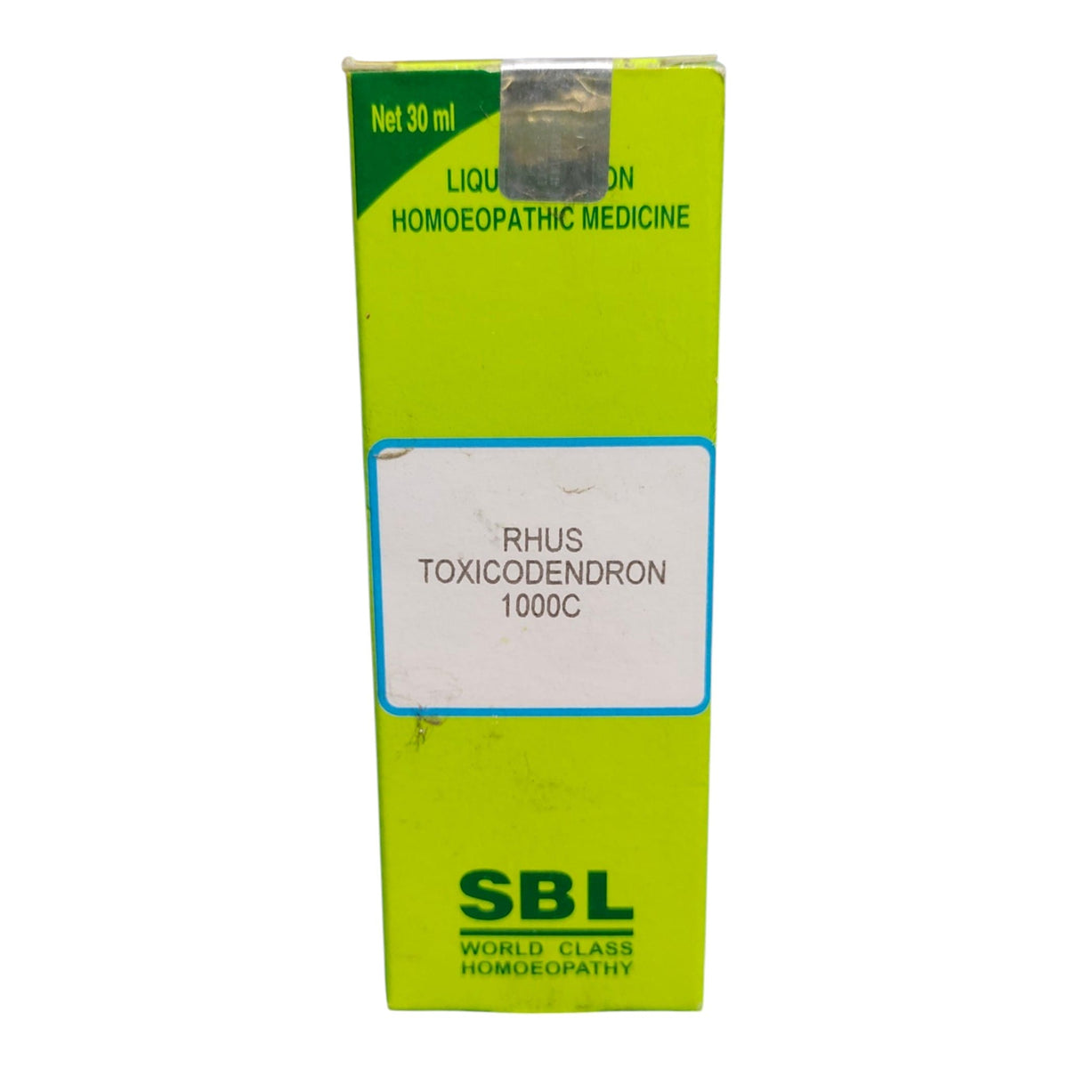 A 30 ml box of SBL World Class Homeopathy Rhin Toxicodendron 1000C liquid homeopathic medicine, featuring a bright lime green box with a white label in the center.