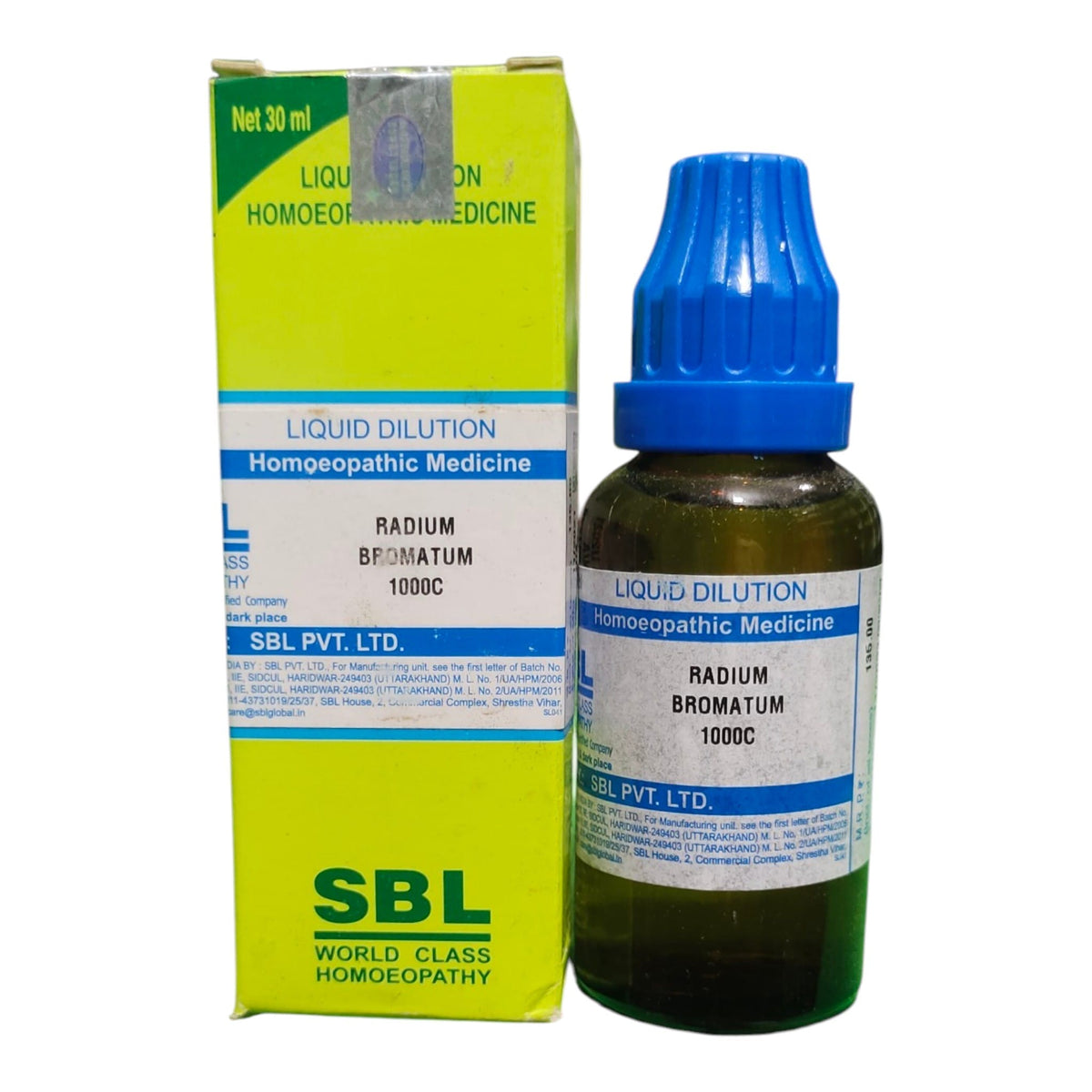 A bottle of SBL World Class Homeopathic Medicine, Radium Bromatum 1000C, with a blue dropper cap next to its lime green and white cardboard box.