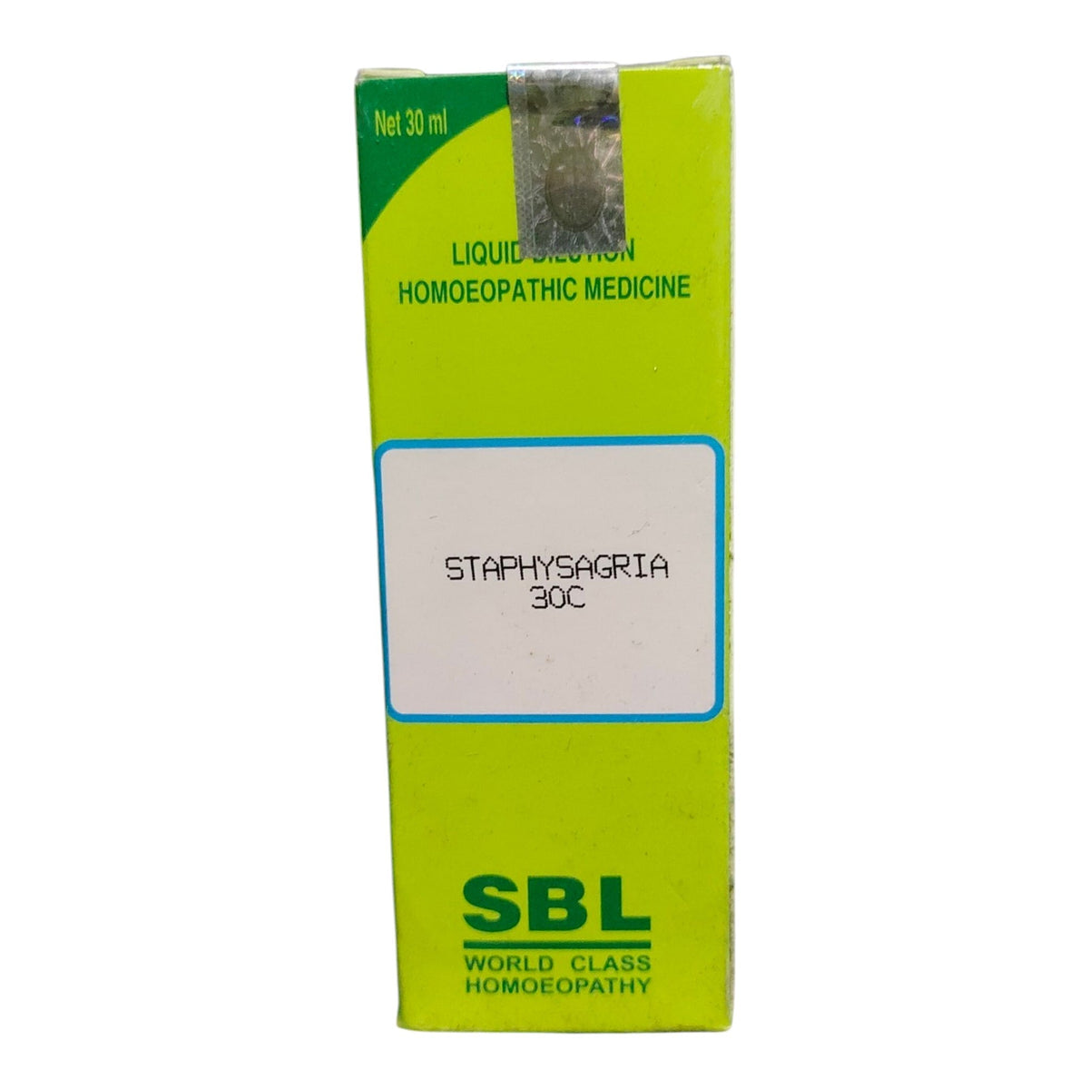 A green and yellow box of SBL Staphyssagia 30C homeopathic medicine, featuring a white label in the center with the product name.