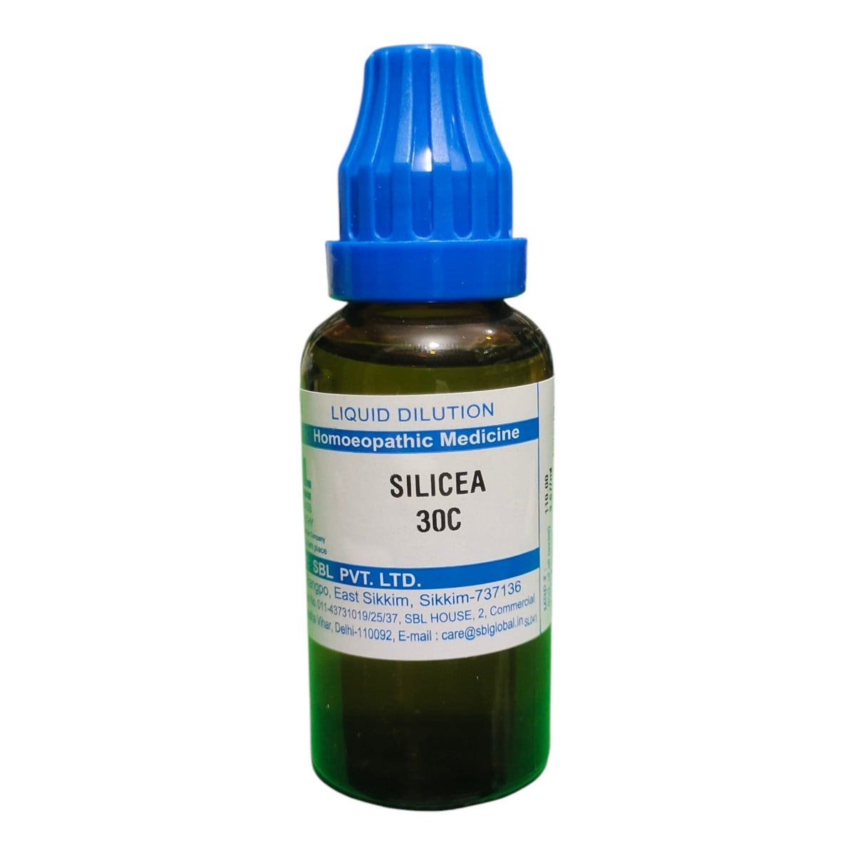A small amber glass dropper bottle of Silicea 30C liquid dilution homeopathic medicine with a blue cap and white label, on a plain white background.