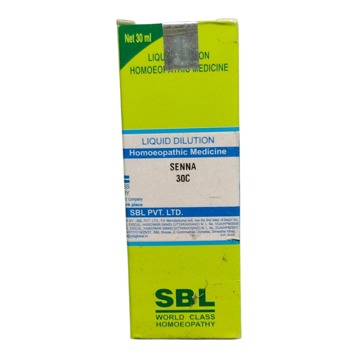 A box of SBL World Class Homoeopathy Senna 30C liquid dilution homeopathic medicine, featuring a bright lime green and white design with blue accents.