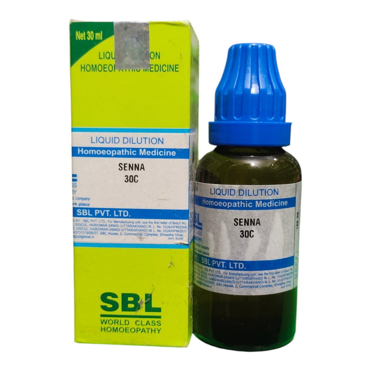 A bottle of Senna 30C liquid dilution homeopathic medicine next to its lime green and white packaging box, featuring a blue dropper cap.
