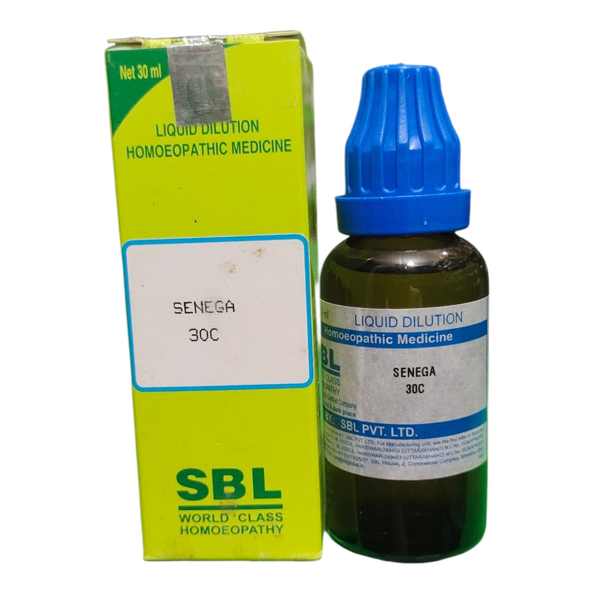 A bottle of SBL Senega 30C liquid dilution homeopathic medicine next to its lime green box, on a plain white background.