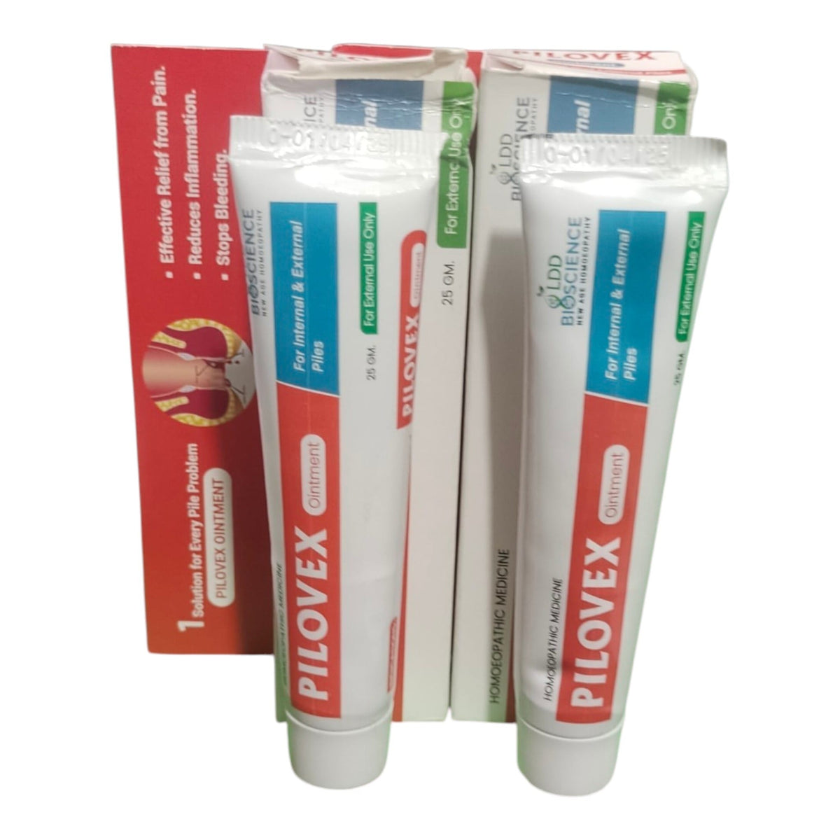 Two white tubes of Pilocvex Ointment with red and blue labels, standing in front of their red and white retail packaging boxes on a white background.