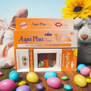 Aqui Plus cream boxes with Easter eggs and a bunny on a wooden surface