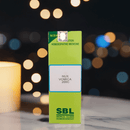 SBL Nux Vomica 200C homeopathic medicine box with blurred lights in the background