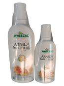 Two bottles of Wheezal Homeopathy Arnica Hair & Scalp Treatment Shampoo, one larger and one smaller, with labels displaying the product information.